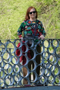 Adult woman on a metal bridge
